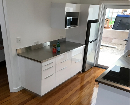 High gloss kitchen benchtop with fridge and microwave